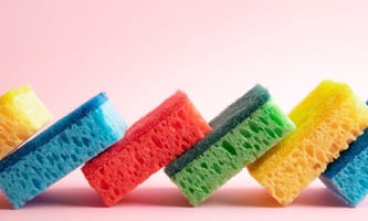 Adhesive systems for kitchen sponges